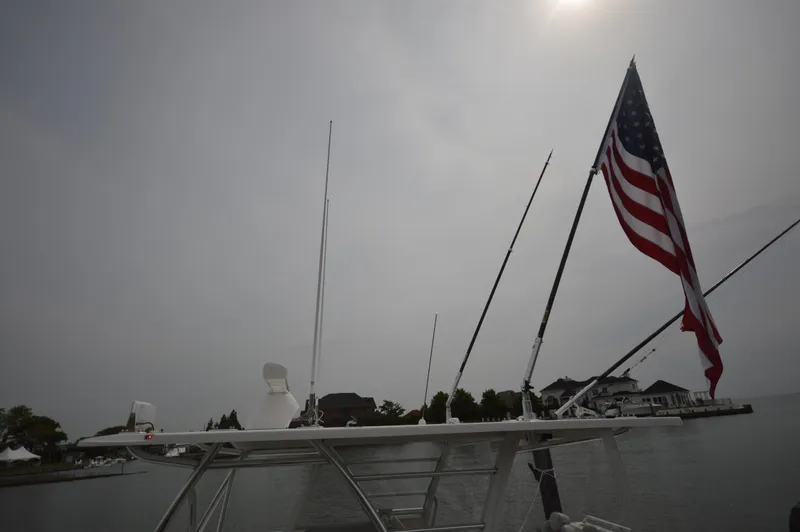 Slide: The Image of 2018 Invincible 43 Open Fisherman boat with American flag in harbor. - 20