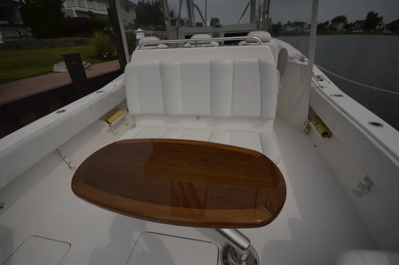 Slide: The Image of 2018 Invincible 43 Open Fisherman boat with white seating and wooden table. - 23