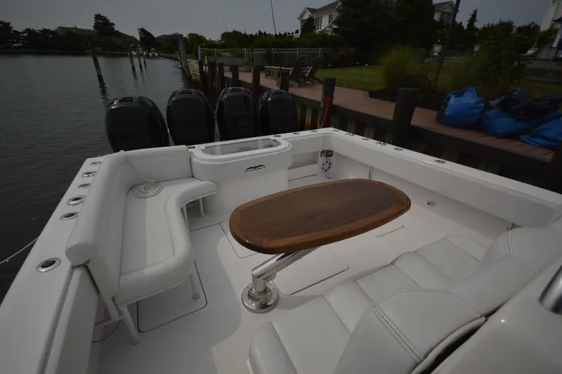 Slide: The Image of 2018 Invincible 43 Open Fisherman boat with white seating and wooden table. - 25