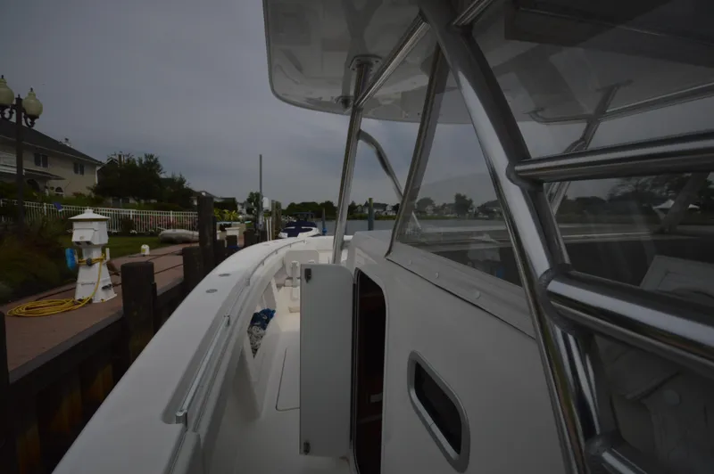 Slide: The Image of 2018 Invincible 43 Open Fisherman docked, showcasing sleek design and spacious deck. - 28