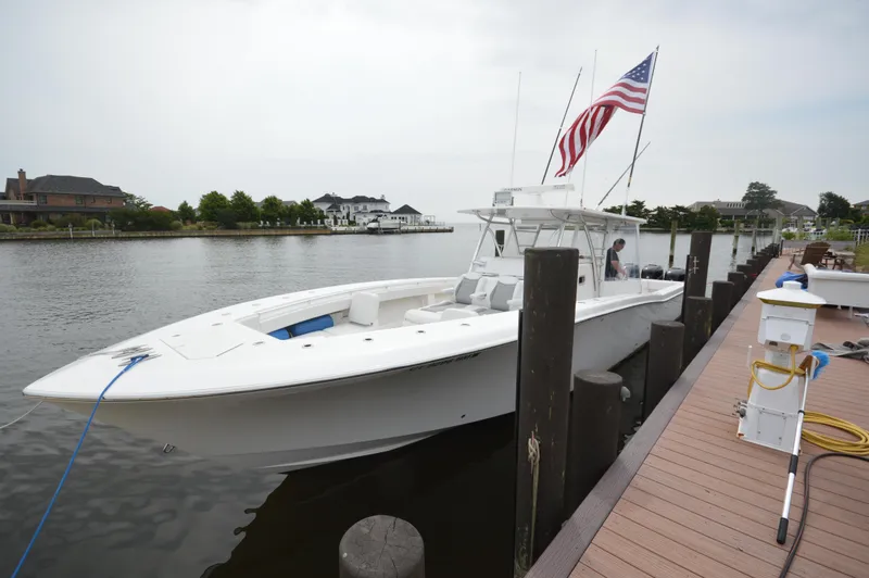Slide: The Image of 2018 Invincible 43 Open Fisherman docked by a waterfront home. - 3