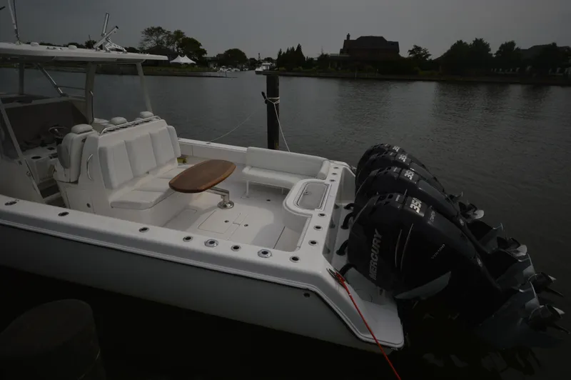 Slide: The Image of 2018 Invincible 43 Open Fisherman boat docked with triple Mercury engines. - 4