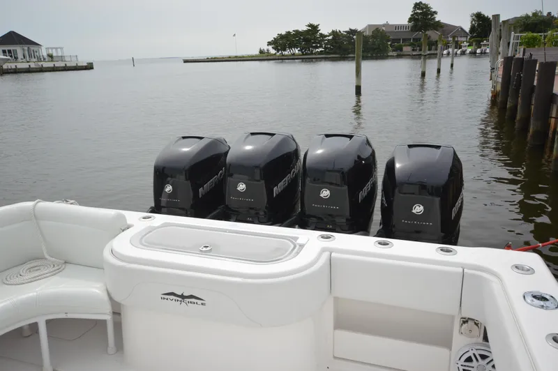 Slide: The Image of 2018 Invincible 43 Open Fisherman with four outboard motors docked by waterfront homes. - 6