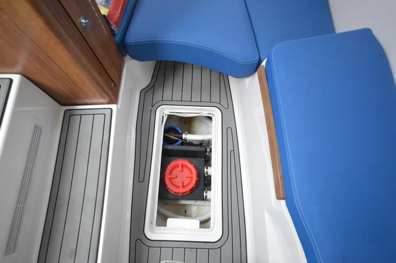 Slide: The Image of 2018 Invincible 43 Open Fisherman deck storage compartment with blue seating. - 9