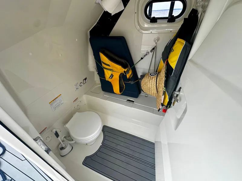 Slide: The Image of 2022 Brig Eagle 8 boat interior with toilet, life jackets, and window. - 11