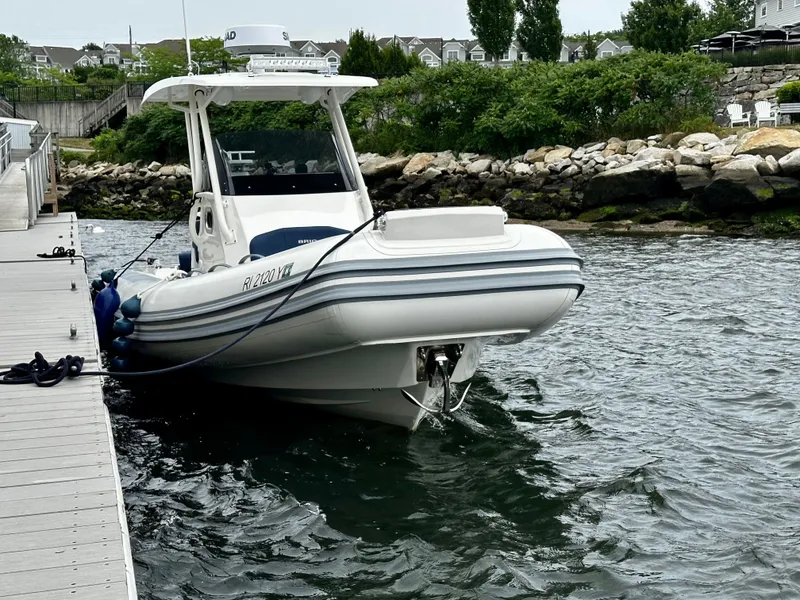 Slide: The Image of 2022 Brig Eagle 8 boat docked at a marina with scenic background. - 15