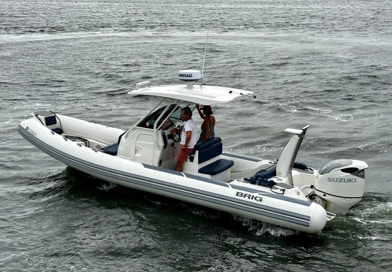 Slide: The Image of 2022 Brig Eagle 8 boat cruising on open water with Suzuki outboard engine. - 19
