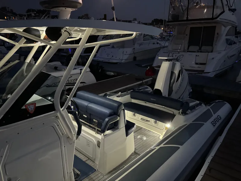 Slide: The Image of 2022 Brig Eagle 8 boat illuminated at night in a marina. - 21