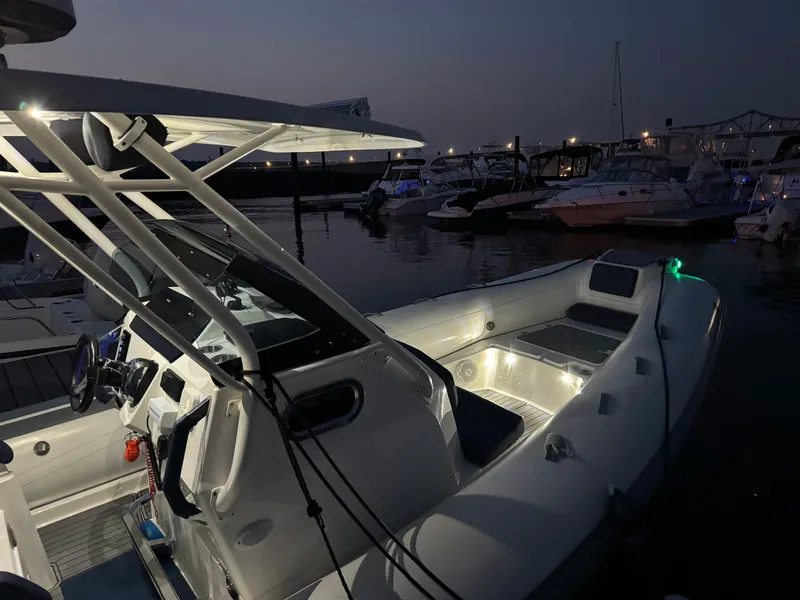 Slide: The Image of 2022 Brig Eagle 8 boat docked at night with interior lights on. - 23