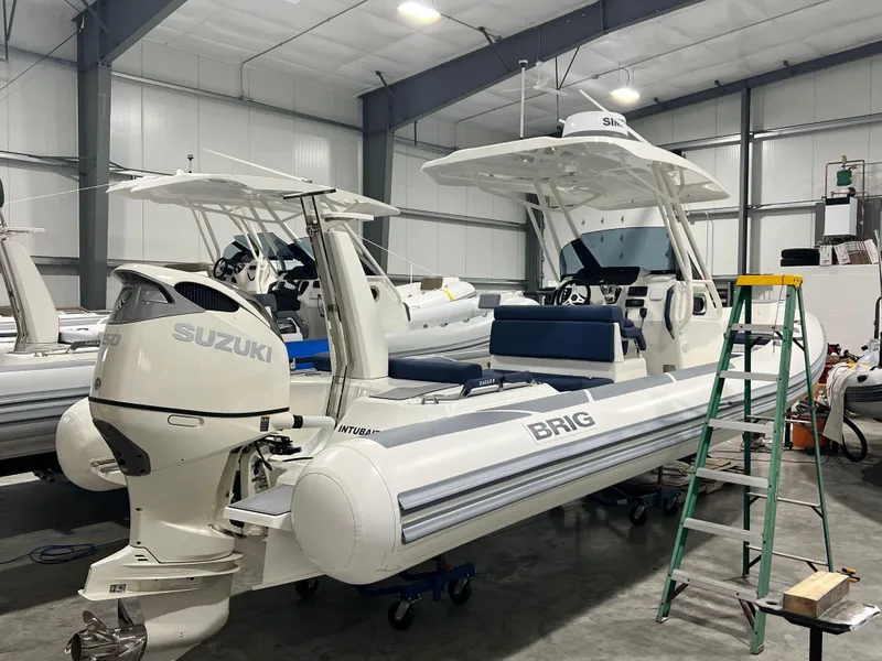 Slide: The Image of 2022 Brig Eagle 8 boat with Suzuki engine in a storage facility. - 24