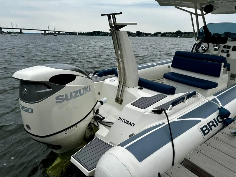 Slide: The Image of 2022 Brig Eagle 8 boat with Suzuki engine docked by the water. - 3