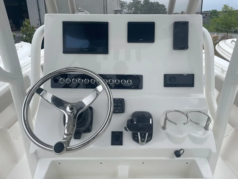 Slide: The Image of Key West 239 FS 2025 boat dashboard with steering wheel, controls, and electronic displays. - 1