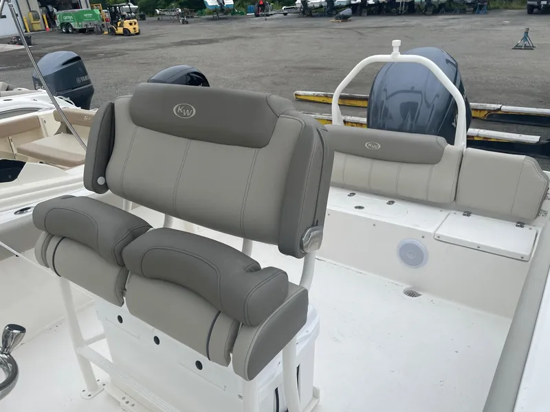 Slide: The Image of 2025 Key West 239 FS boat interior with cushioned seating and Yamaha outboard motor. - 5