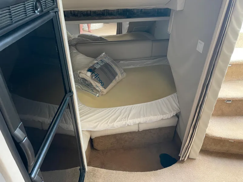 Slide: The Image of Interior cabin of a 1997 Formula 40 boat with a bed and storage. - 10