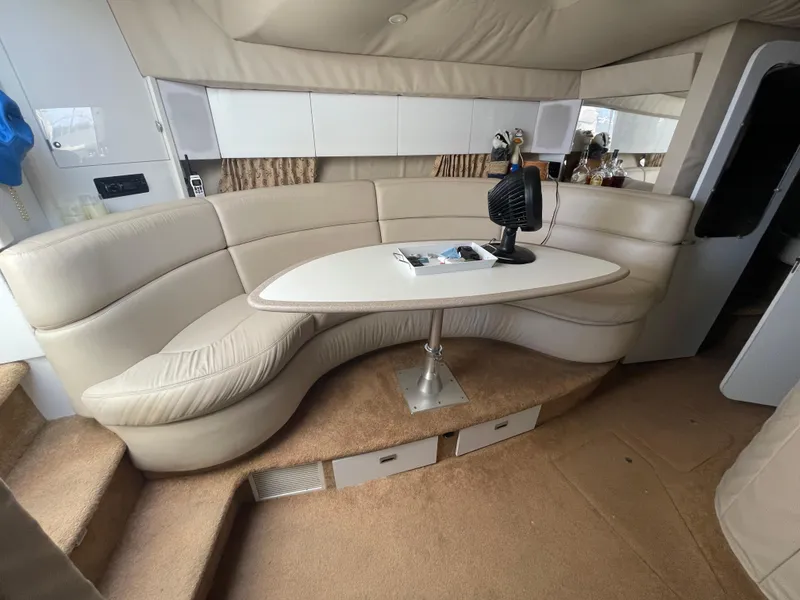 Slide: The Image of 1997 Formula 40 yacht interior with curved seating and table. - 11