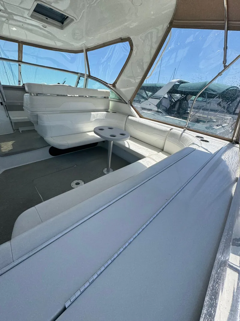 Slide: The Image of 1997 Formula 41 PC yacht interior with white seating and round table, featuring large windows. - 15