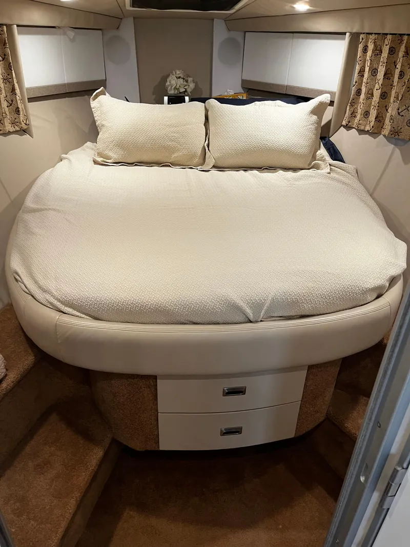 Slide: The Image of Cozy bedroom in a 1997 Formula 40 boat with a neatly made bed. - 16