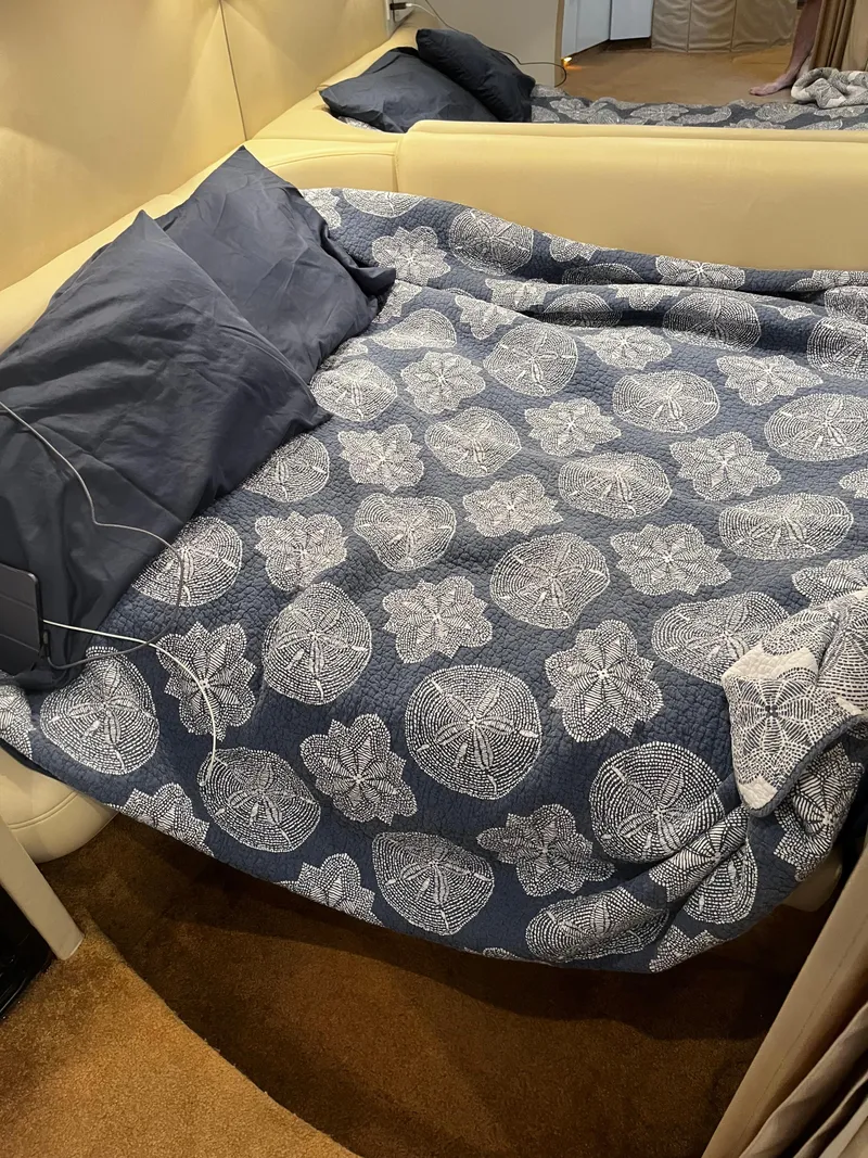 Slide: The Image of Bed in 1997 Formula 40 boat cabin with blue patterned quilt and pillows. - 17