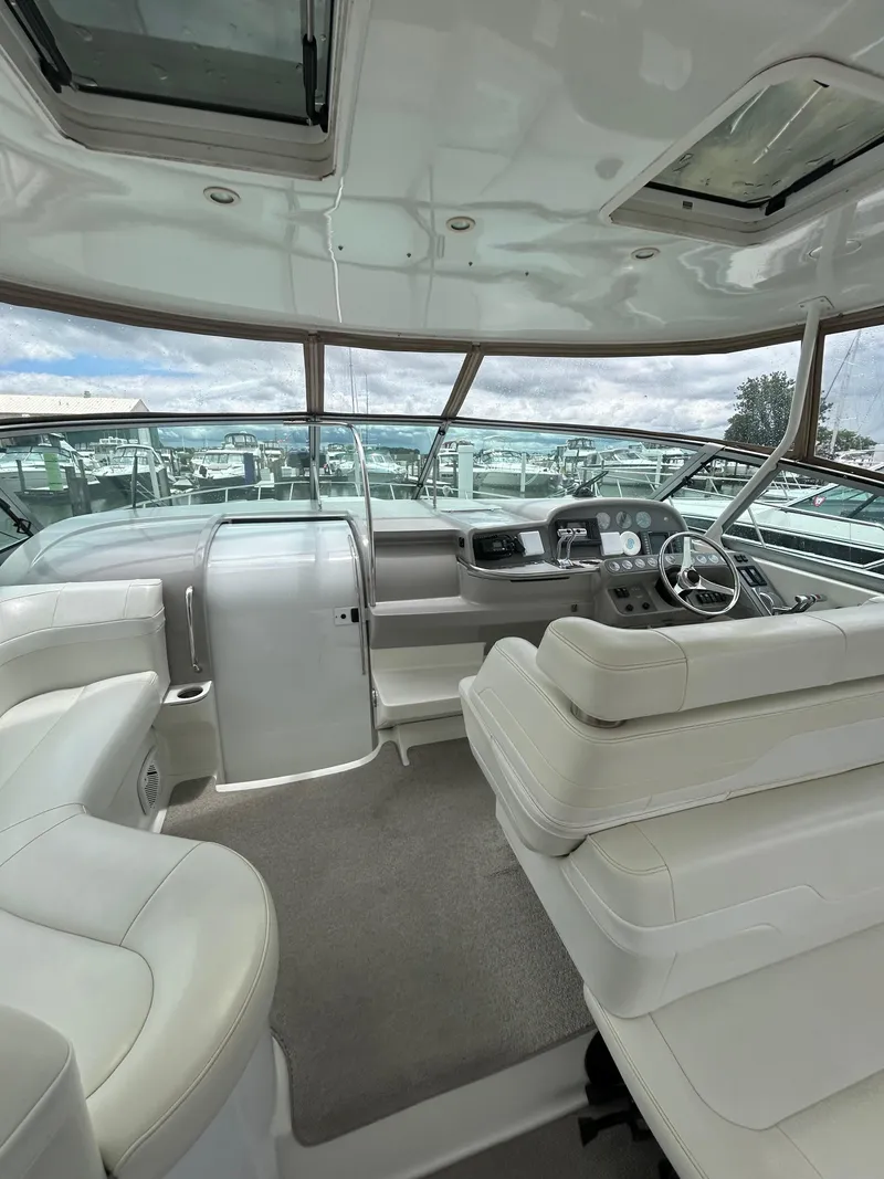 Slide: The Image of Interior of a 1997 Formula 41 PC yacht with white seating and modern dashboard. - 19