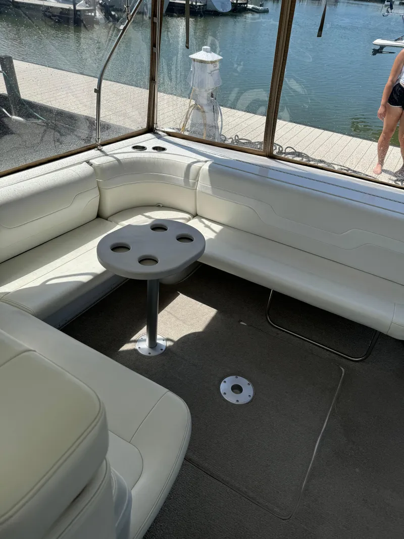 Slide: The Image of Interior of a 1997 Formula 41 PC boat with white seating and table. - 21