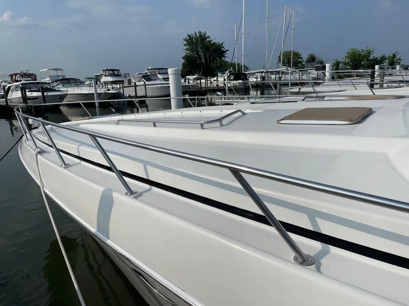 Slide: The Image of 1997 Formula 40 boat docked at a marina with other boats. - 6