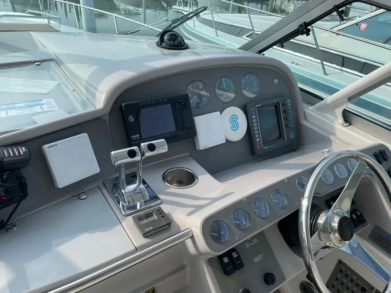 Slide: The Image of 1997 Formula 40 boat dashboard with navigation instruments and steering wheel. - 7