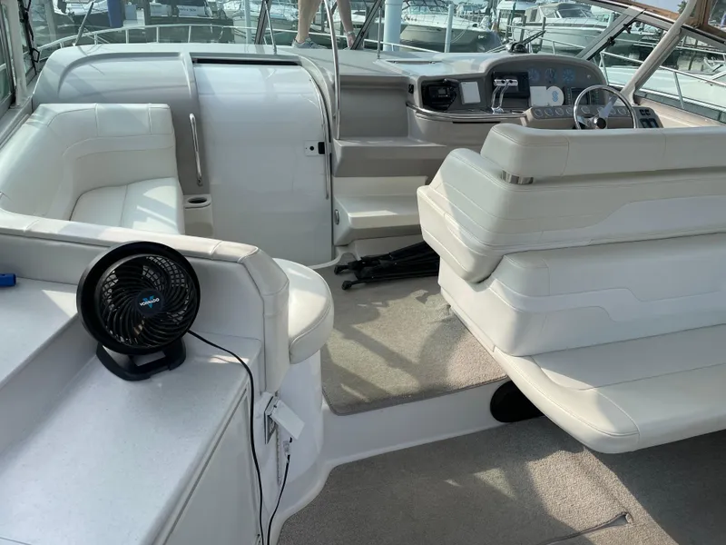 Slide: The Image of Interior of a 1997 Formula 40 boat with white seating and a Vornado fan. - 9