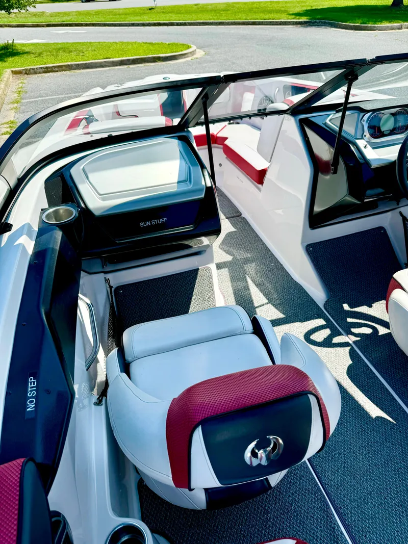 Slide: The Image of 2015 Scarab 215 HO Impulse boat interior with red and white seating, sleek design. - 14