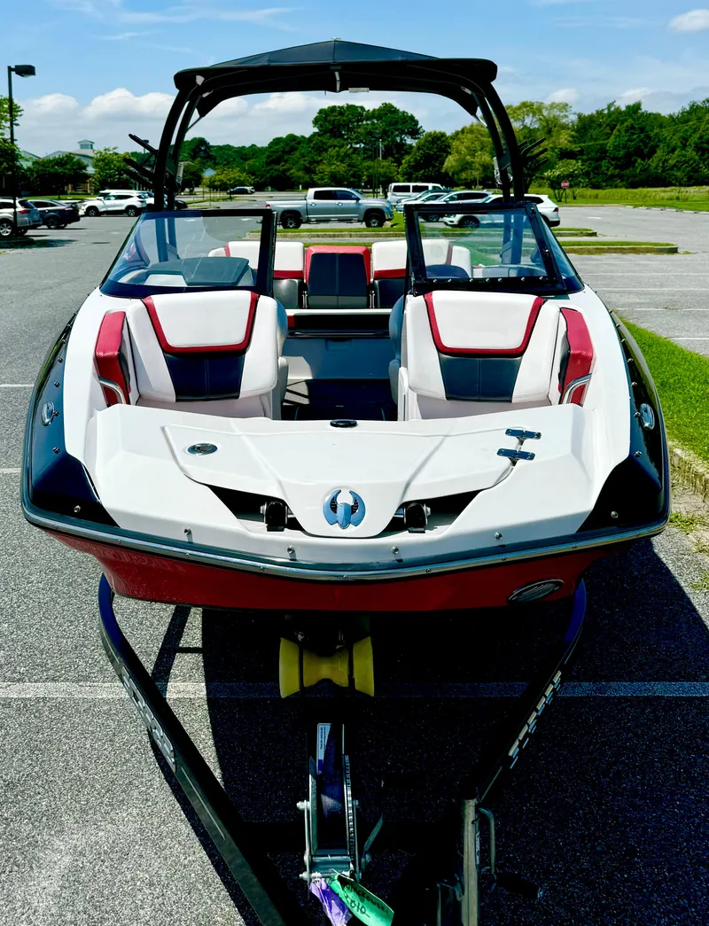 Slide: The Image of 2015 Scarab 215 HO Impulse boat on trailer in parking lot. - 18