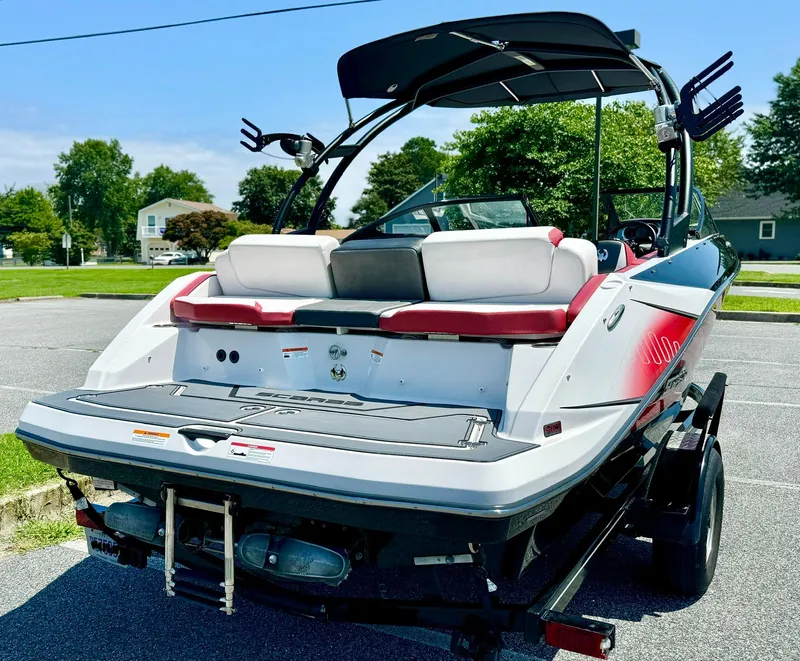 Slide: The Image of 2015 Scarab 215 HO Impulse boat, rear view, parked on trailer, sunny day. - 23