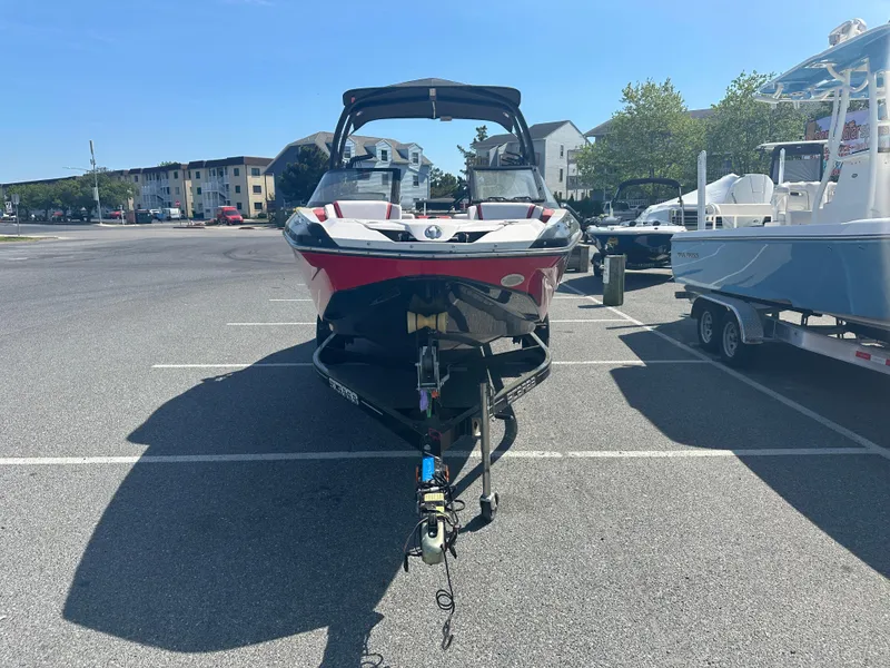 Slide: The Image of 2015 Scarab 215 HO Impulse boat on trailer in parking lot. - 3
