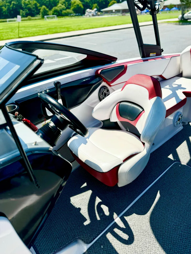 Slide: The Image of 2015 Scarab 215 HO Impulse boat interior with modern seating and steering wheel. - 32