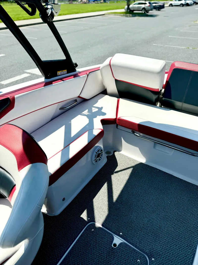 Slide: The Image of 2015 Scarab 215 HO Impulse boat interior with red and white seating. - 33