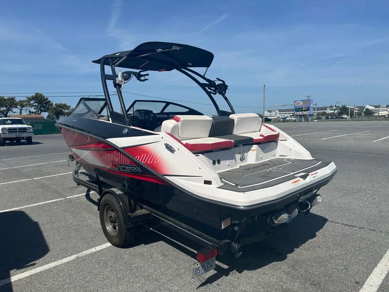 Slide: The Image of 2015 Scarab 215 HO Impulse boat in parking lot, rear view. - 4