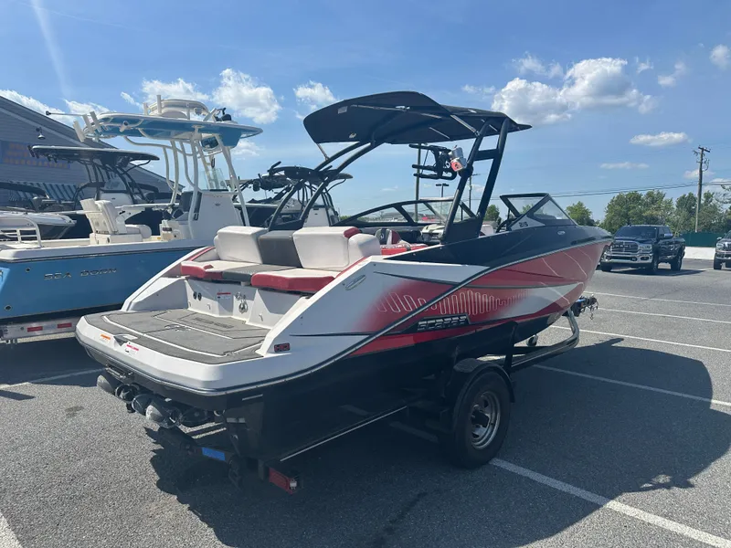 Slide: The Image of 2015 Scarab 215 HO Impulse boat in parking lot, rear view. - 5