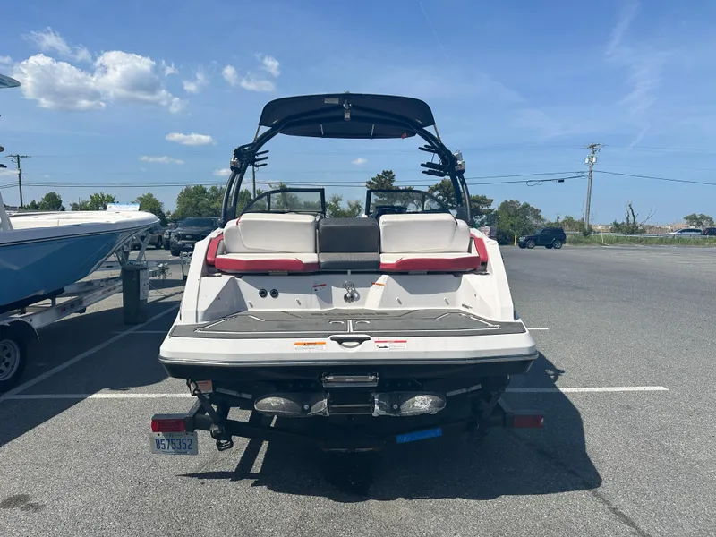 Slide: The Image of 2015 Scarab 215 HO Impulse boat, rear view, parked on a trailer in a lot. - 6