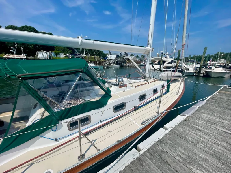 Slide: The Image of 2001 Tartan 4100 sailboat docked at marina under clear blue sky. - 10