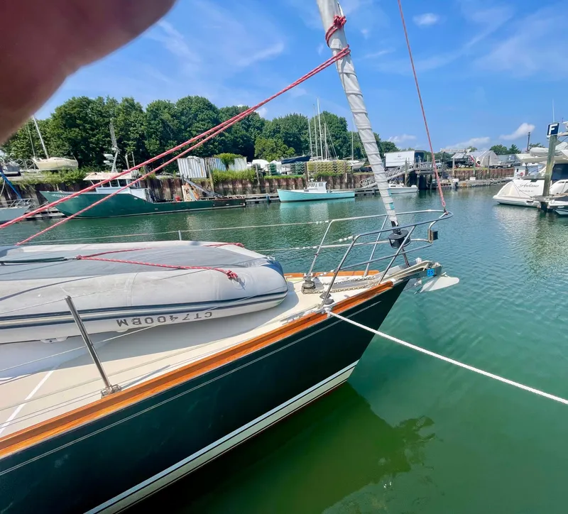 Slide: The Image of Sailboat Tartan 4100 (2001) docked in a marina under a clear blue sky. - 13