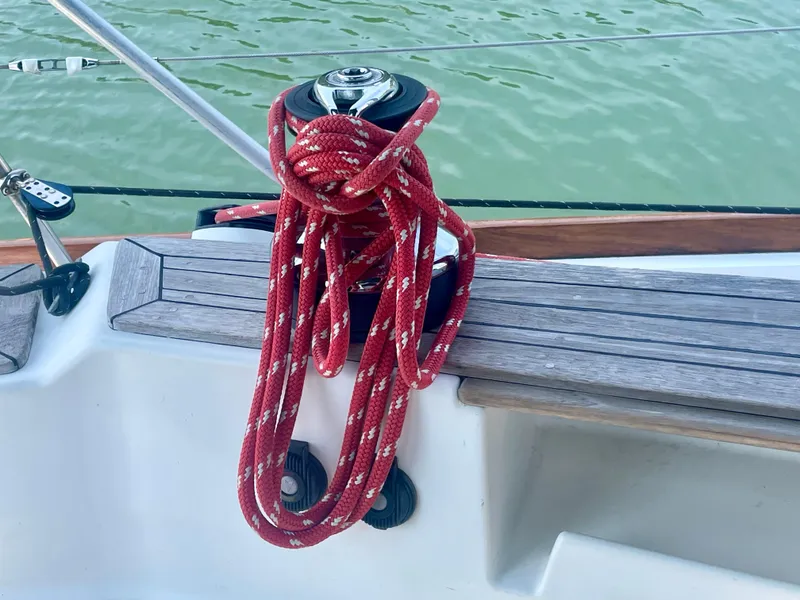 Slide: The Image of Red rope on Tartan 4100 sailboat winch, 2001 model, by the water. - 16
