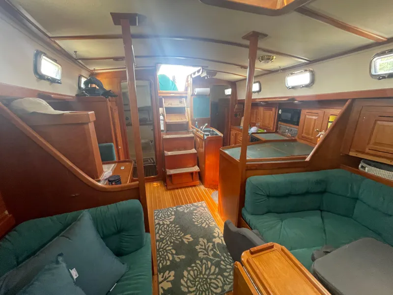 Slide: The Image of Interior of 2001 Tartan 4100 sailboat with wooden cabinetry and green seating. - 20
