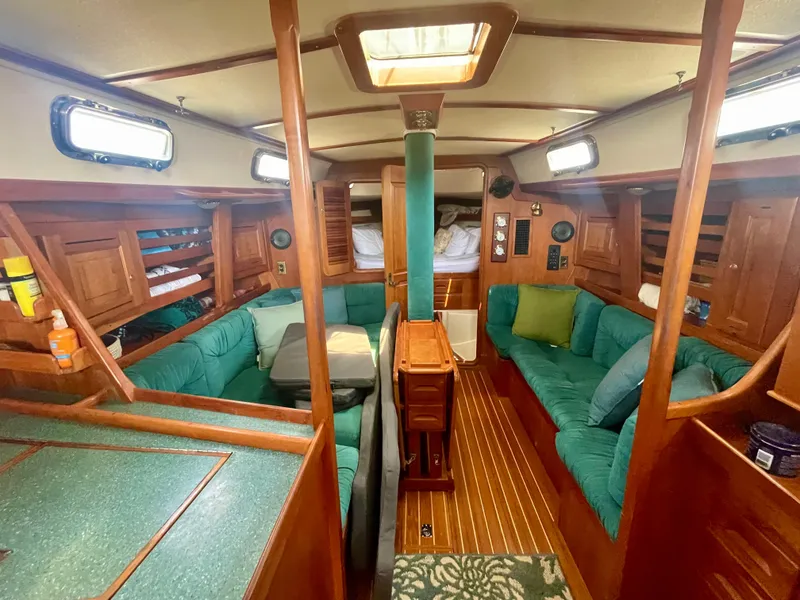 Slide: The Image of Interior of 2001 Tartan 4100 sailboat with green seating and wooden finishes. - 21