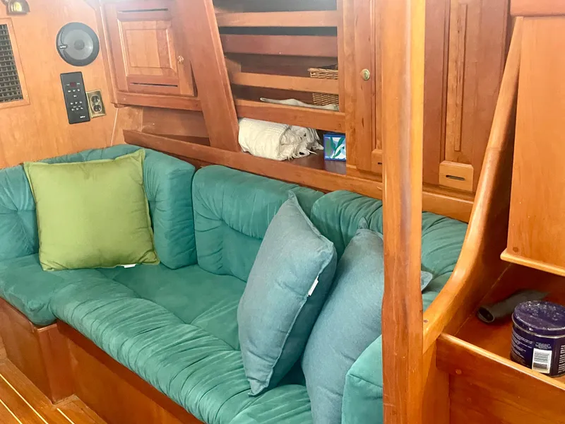 Slide: The Image of Cozy interior of 2001 Tartan 4100 sailboat with green cushions and wooden finish. - 22