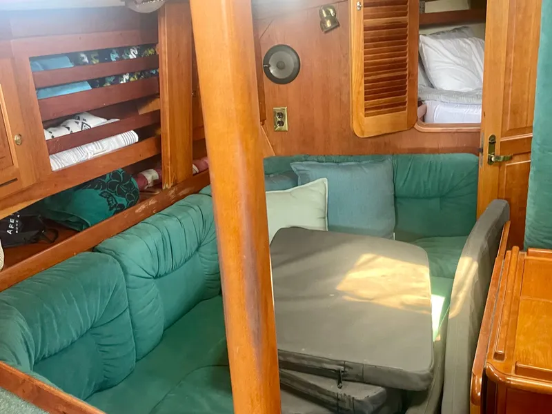 Slide: The Image of Cozy interior of 2001 Tartan 4100 sailboat with green cushions and wooden accents. - 23