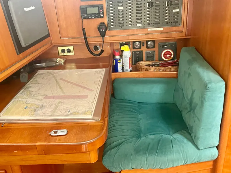Slide: The Image of Navigation station on 2001 Tartan 4100 yacht with chart, radio, and control panel. - 28