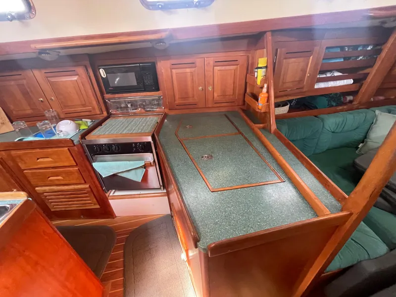 Slide: The Image of Tartan 4100 yacht interior kitchen with wooden cabinets and green countertops, 2001 model. - 31