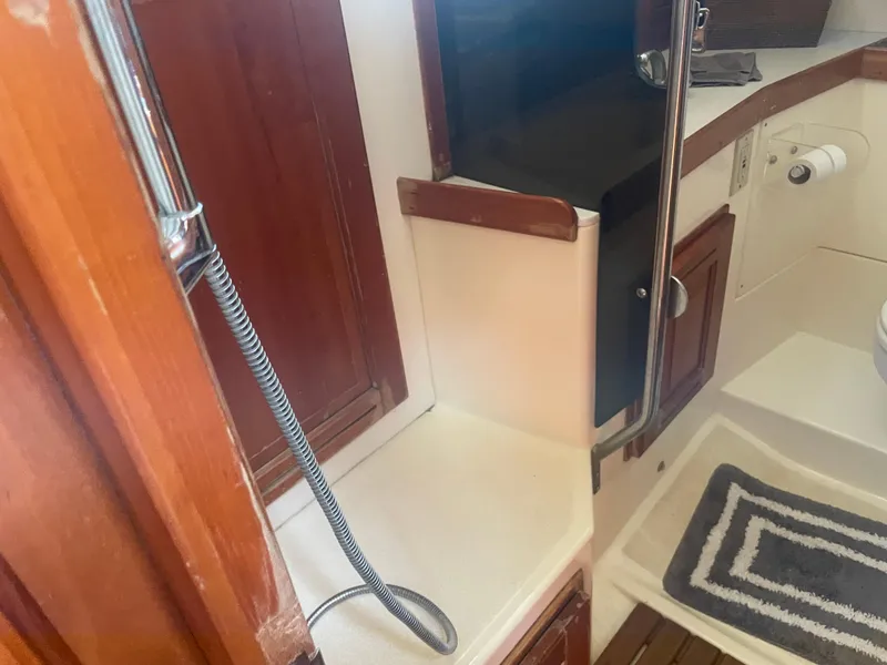 Slide: The Image of Interior of 2001 Tartan 4100 yacht bathroom with shower and wooden cabinetry. - 32