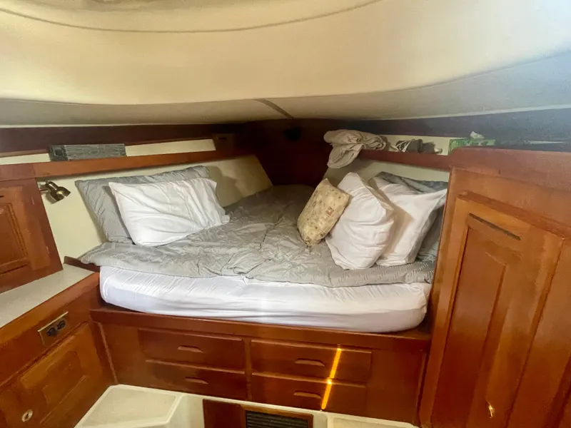 Slide: The Image of Cozy cabin interior of 2001 Tartan 4100 sailboat with wooden furnishings and bedding. - 33
