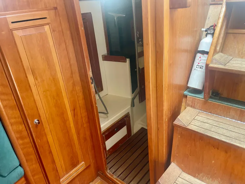 Slide: The Image of Interior of 2001 Tartan 4100 sailboat with wooden cabinetry and stairs. - 34