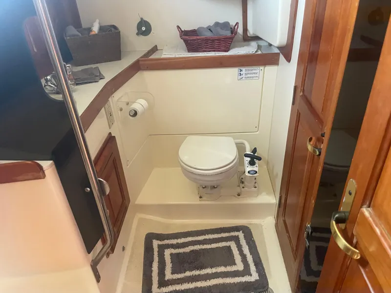 Slide: The Image of Compact bathroom in 2001 Tartan 4100 sailboat with wooden accents and nautical decor. - 35