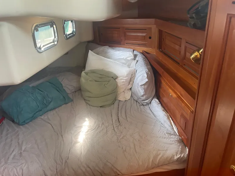 Slide: The Image of Cozy cabin interior of 2001 Tartan 4100 sailboat with bed and wooden storage. - 36